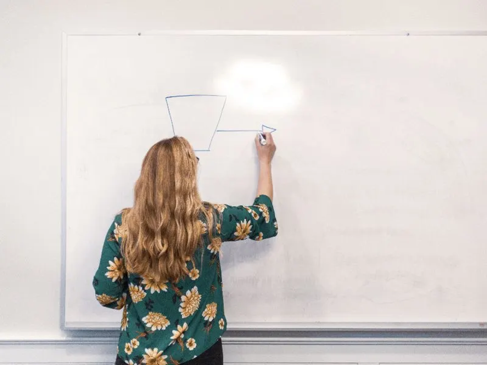 A planner sketching event ideas on a whiteboard