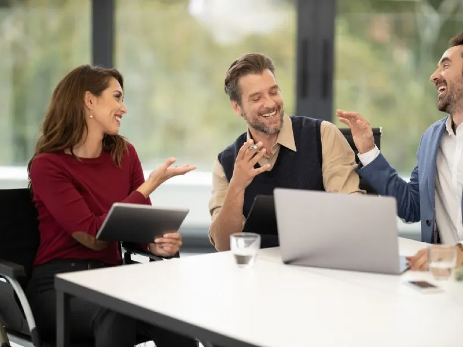 Colleagues discussing plans around a conference table